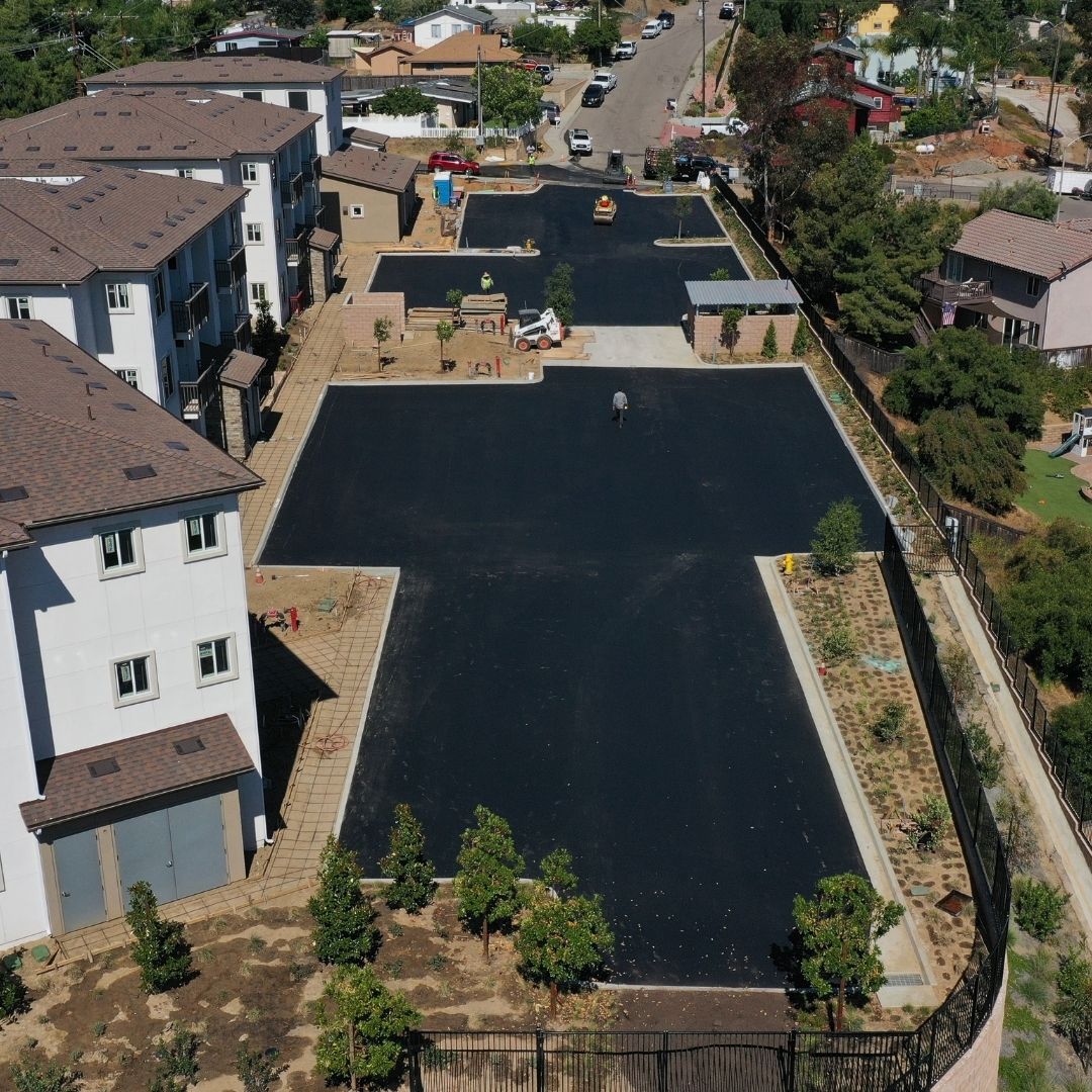 Freshly laid asphalt in front of an apartment complex